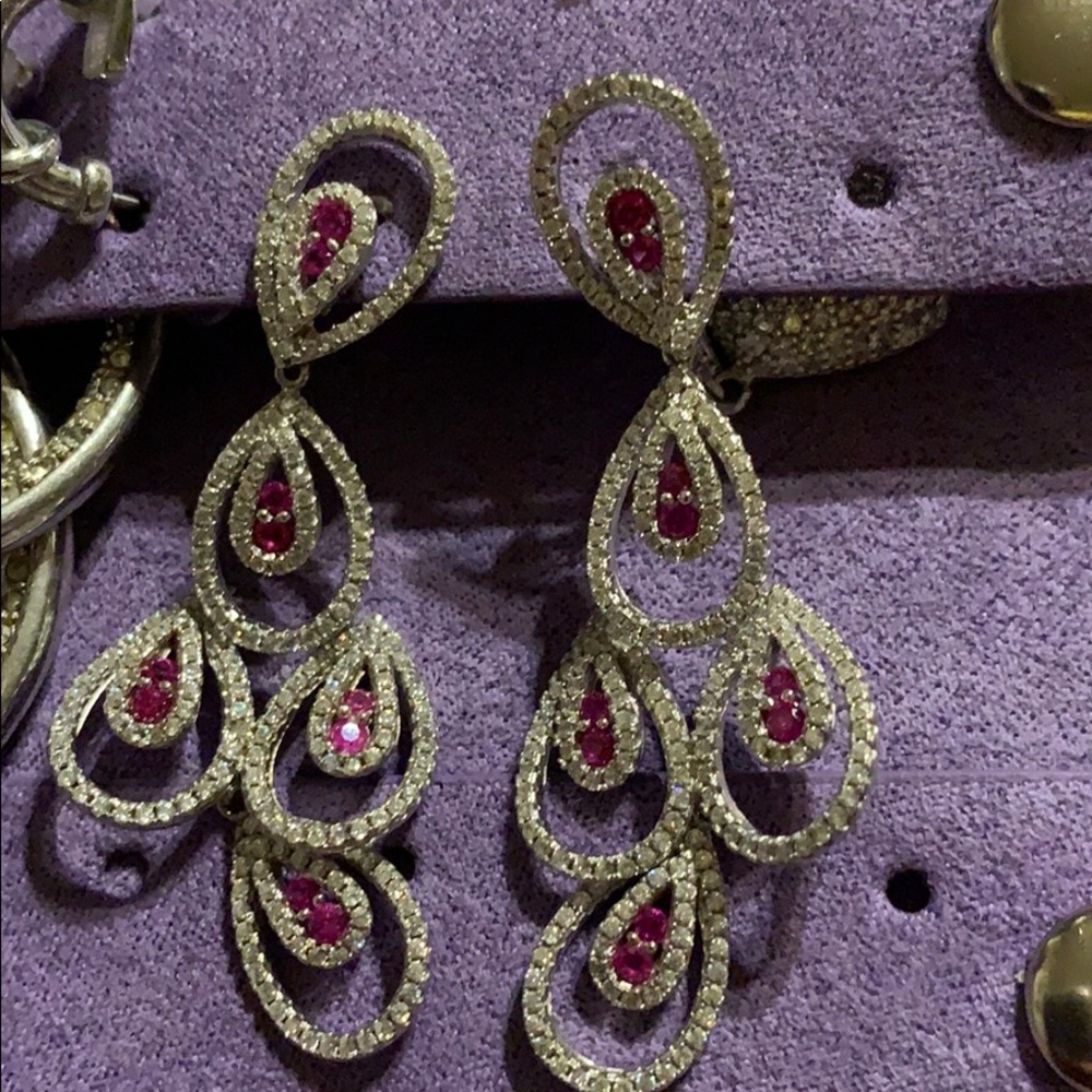 Silver and ruby stones and zirconium.